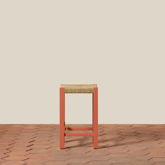 Bar stool with woven seat on a wooden floor and beige wall background - Image 2