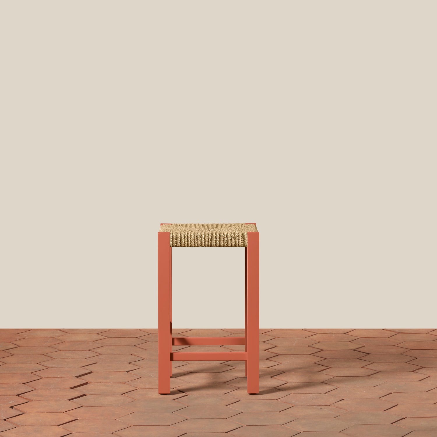 Bar stool with woven seat on a wooden floor and beige wall background- Number 2
