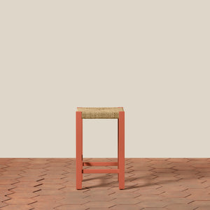 Bar stool with woven seat on a wooden floor and beige wall background - Number 2
