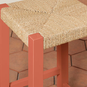 Bar stool with woven seat and red frame on a wooden floor - Number 4