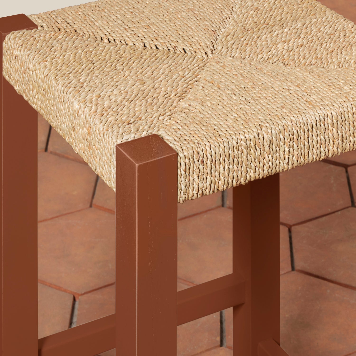 Brown stool with woven seat on a tiled floor- Number 8