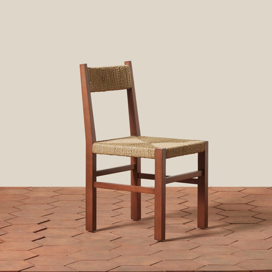 Wooden chair with woven seat and backrest on a wooden floor.