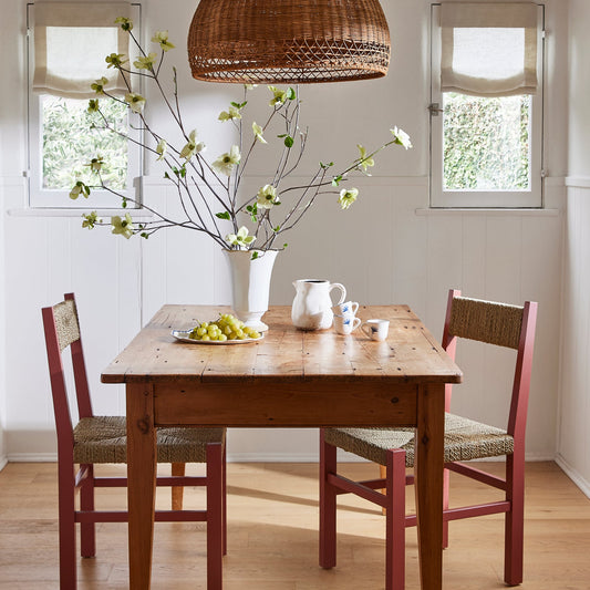 Dining room with wooden table, chairs, and decorative elements. - Image 2