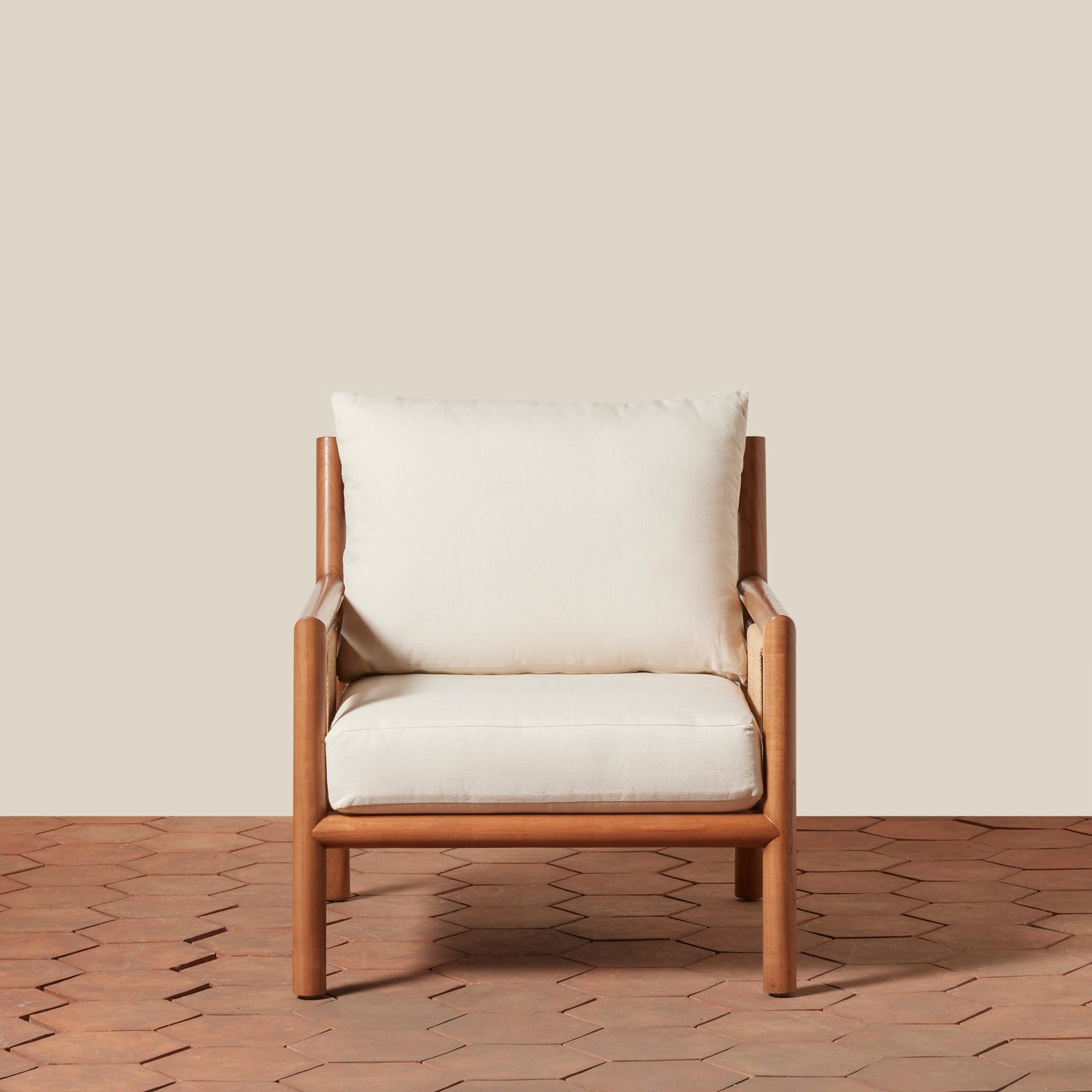 Wooden armchair with white cushions on a wooden floor and beige wall background- Number 3
