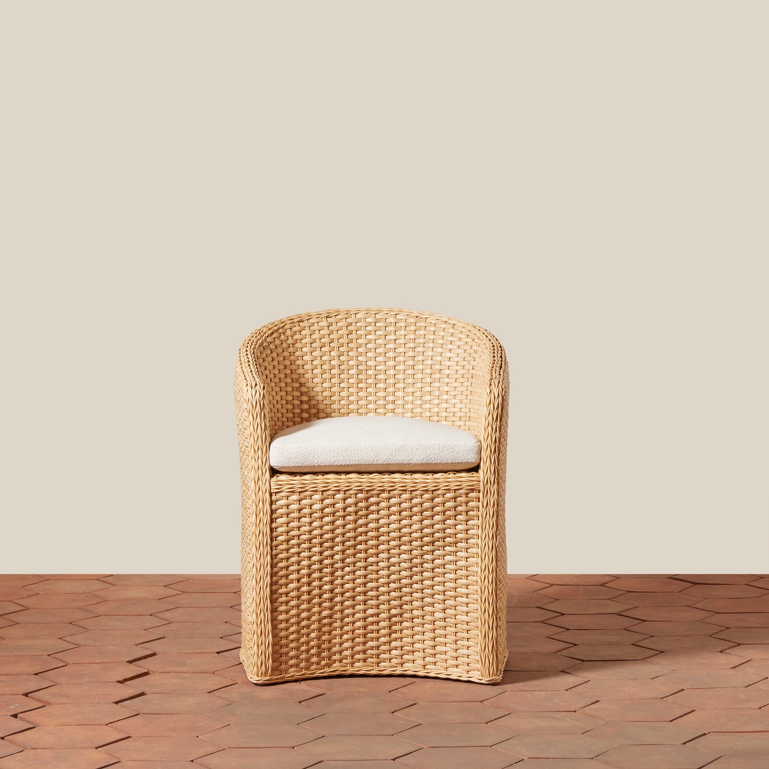 Woven chair with a white cushion on a wooden floor and beige wall- Number 2
