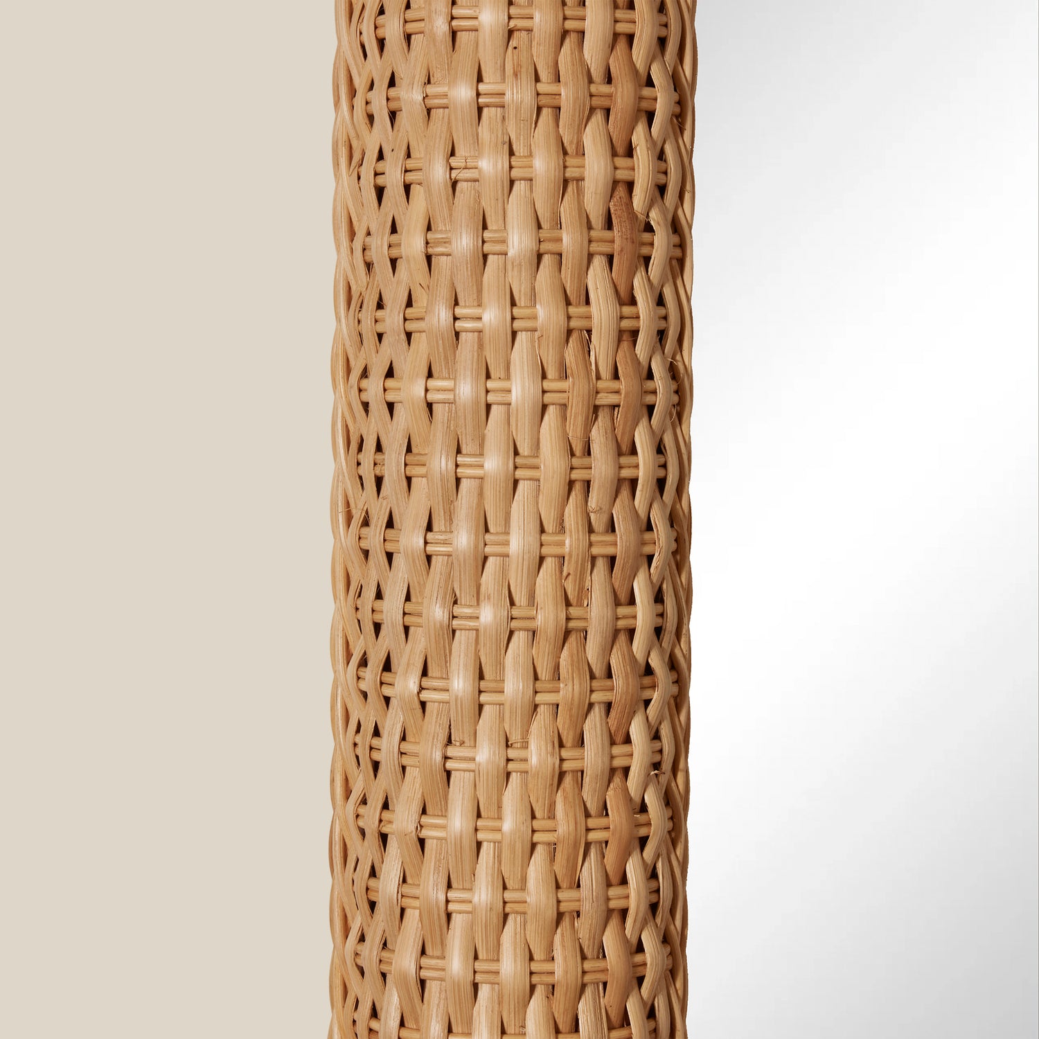 Woven rattan mirror on a plain background- Number 2