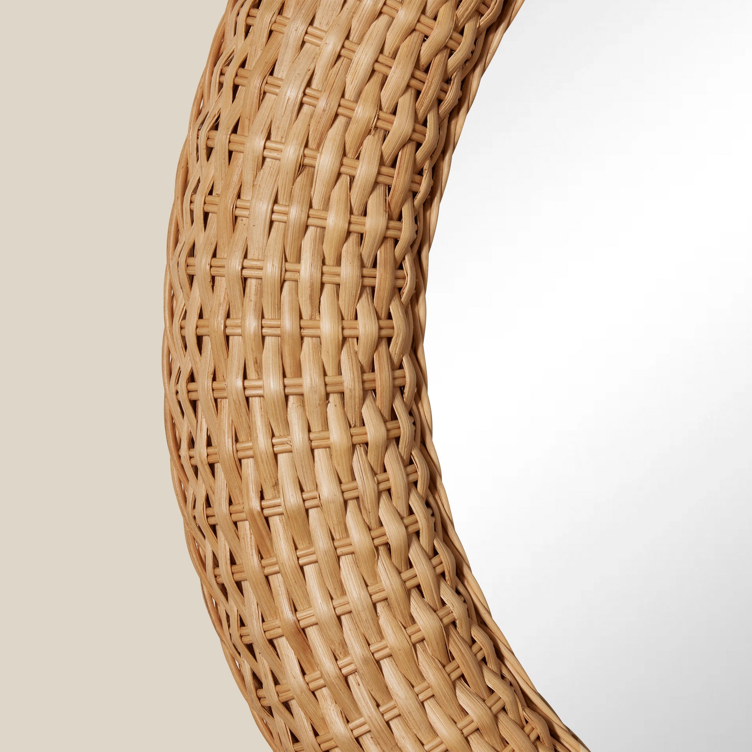 Close-up of a woven rattan chair armrest on a neutral background- Number 2