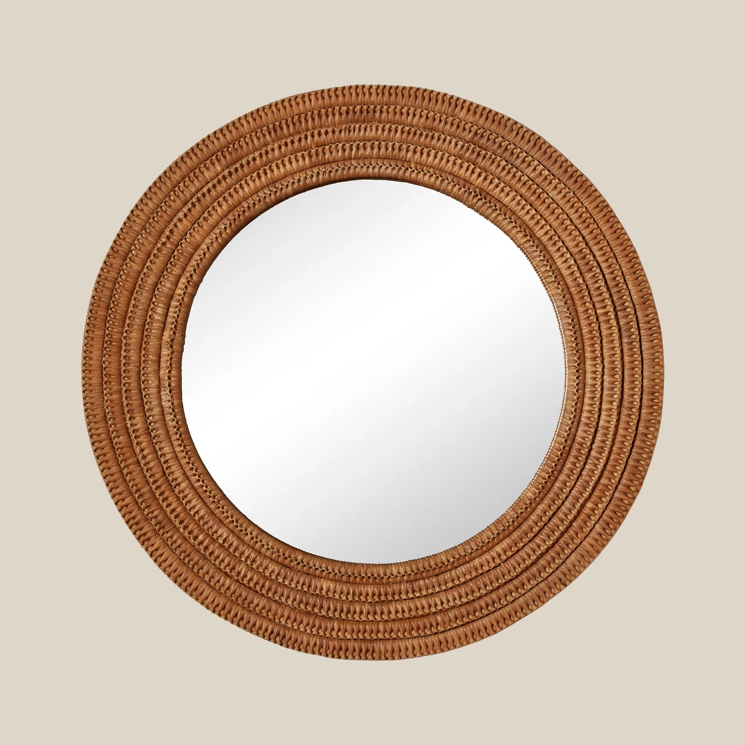 Round mirror with a woven brown frame on a beige wall- Number 1