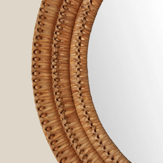 Close-up of a woven brown circular mirror on a light beige background - Image 2