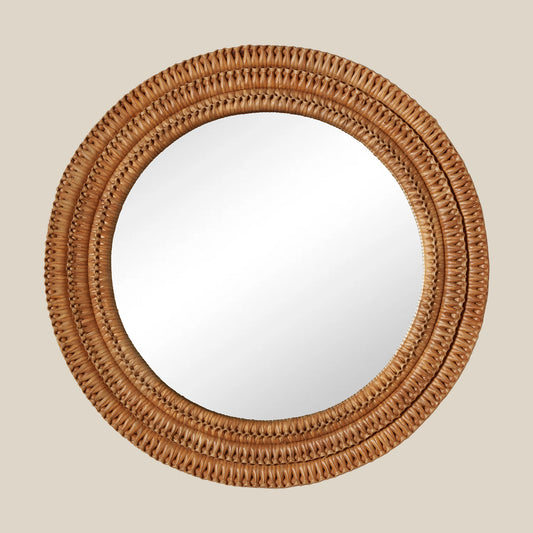 Round mirror with a woven brown frame on a beige background