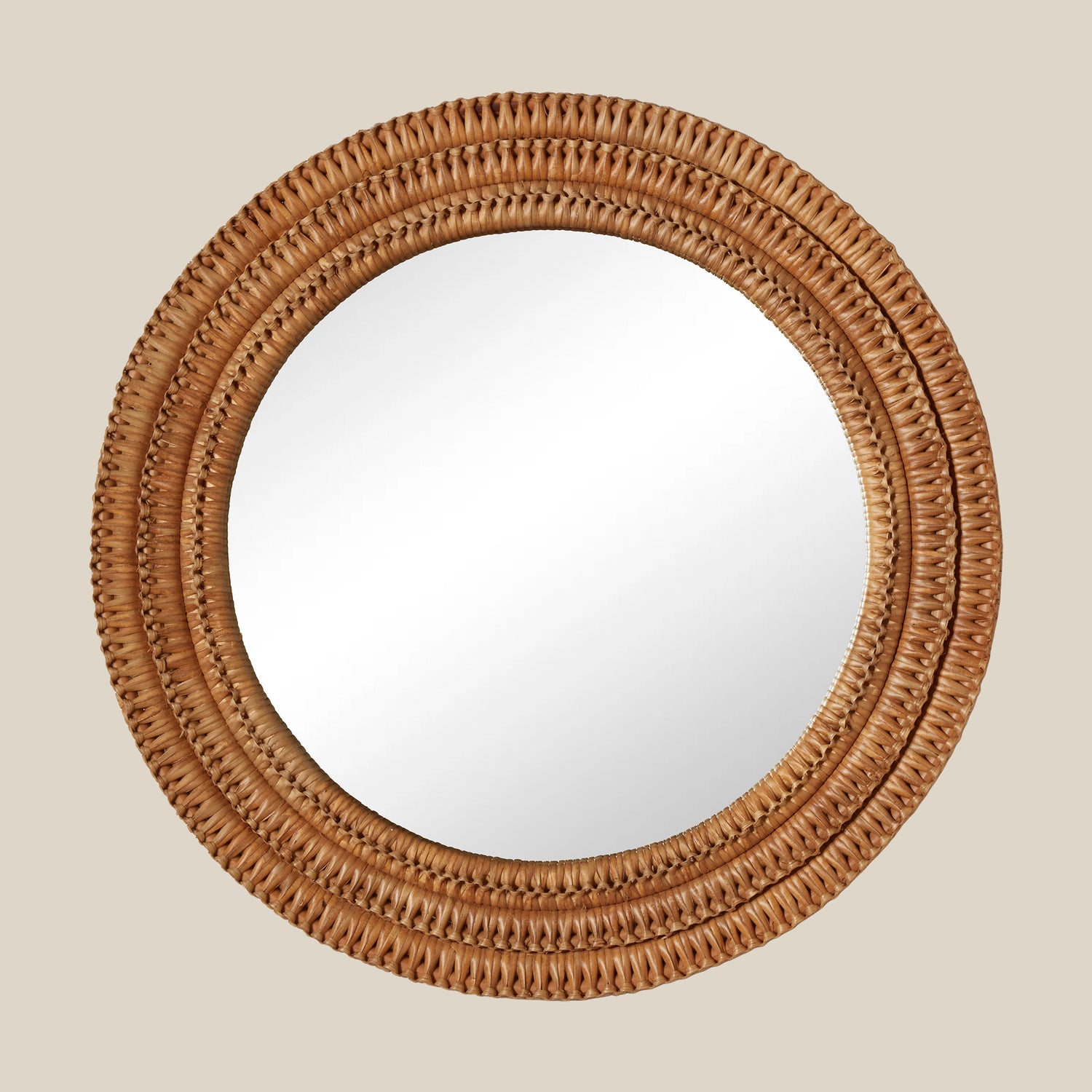 Round mirror with a woven brown frame on a beige background- Number 1