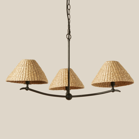 Chandelier with three woven lampshades on a beige background