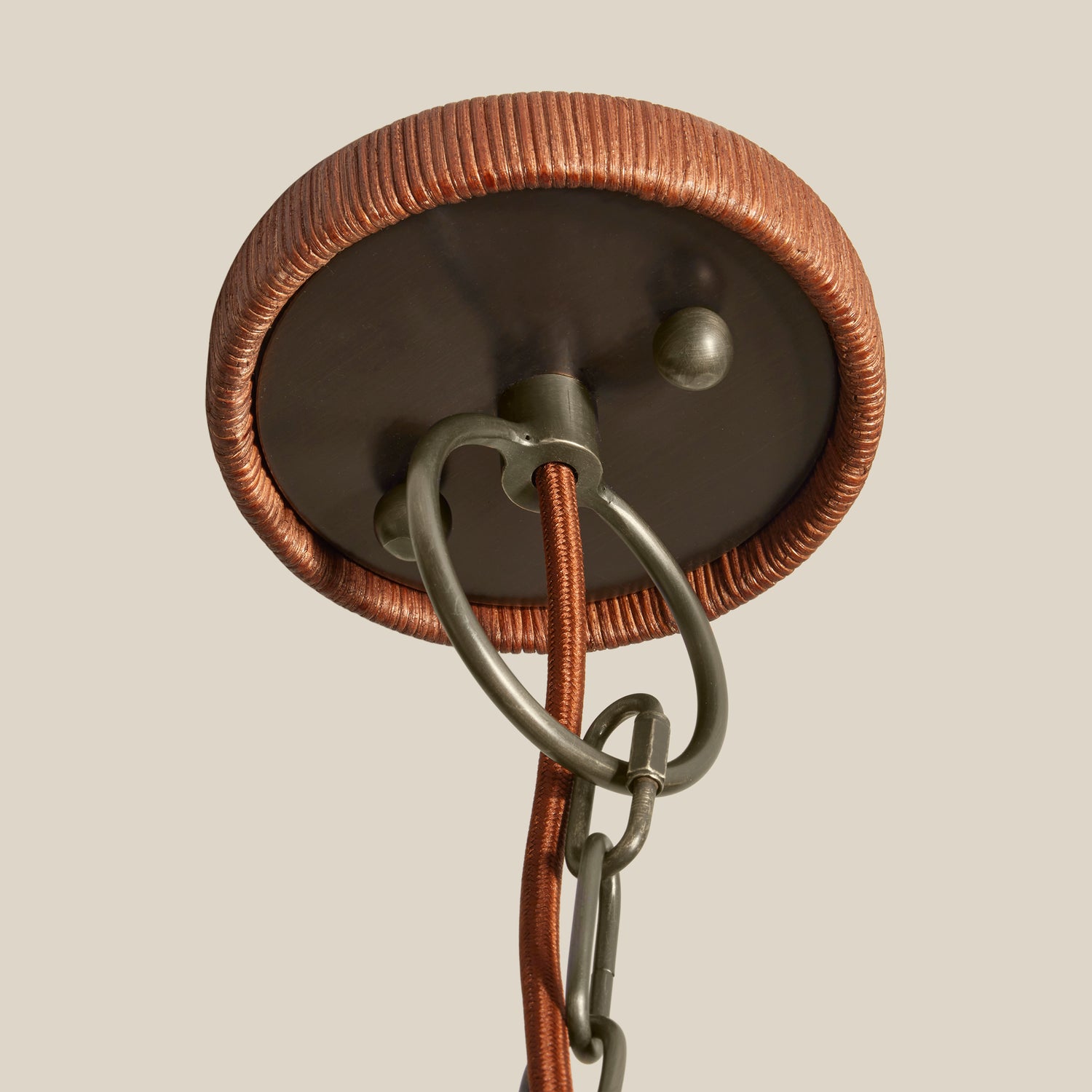 Close-up of a ceiling light fixture with copper and bronze finish on a beige background- Number 5
