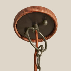 Close-up of a ceiling light fixture with copper and bronze finish on a beige background - Number 5