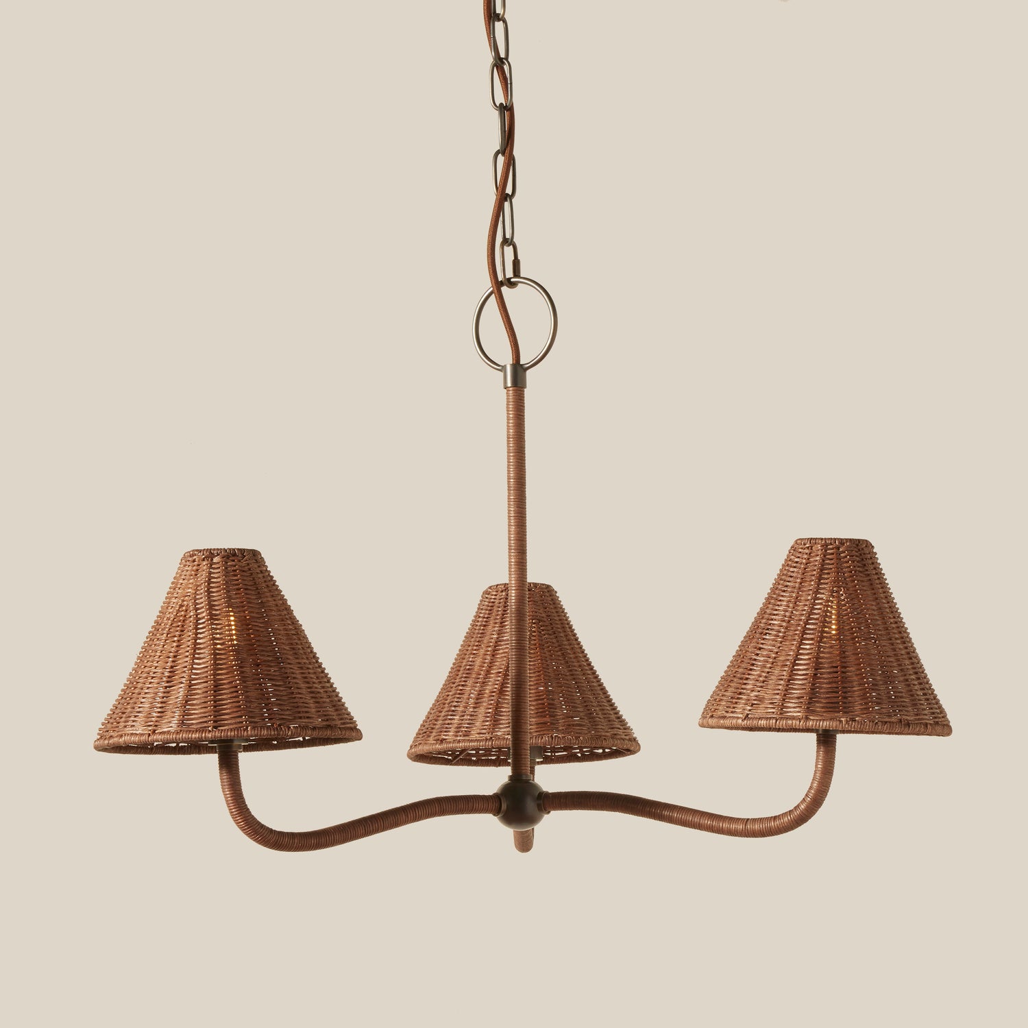 Wicker chandelier with three lampshades on a beige background- Number 1