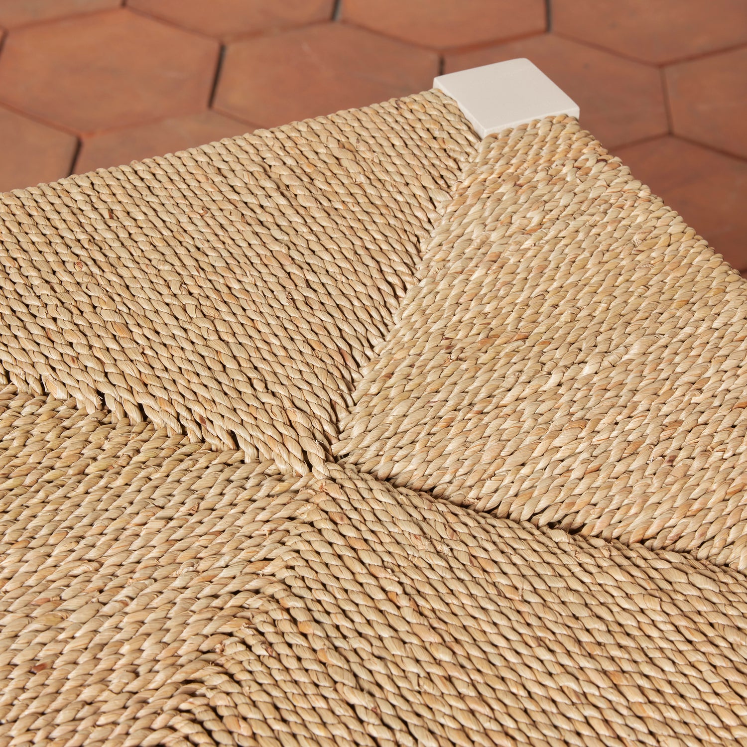 Close-up of a woven mat on a hexagonal tile floor- Number 11