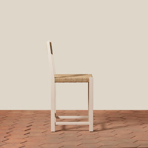 Wooden chair with woven seat on a wooden floor and beige wall - Number 14