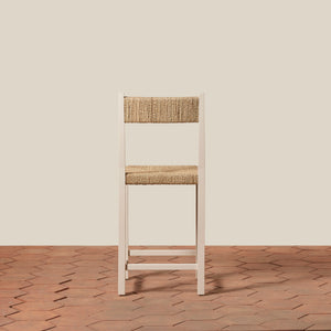 Wooden chair with woven backrest on a wooden floor and beige wall - Number 16
