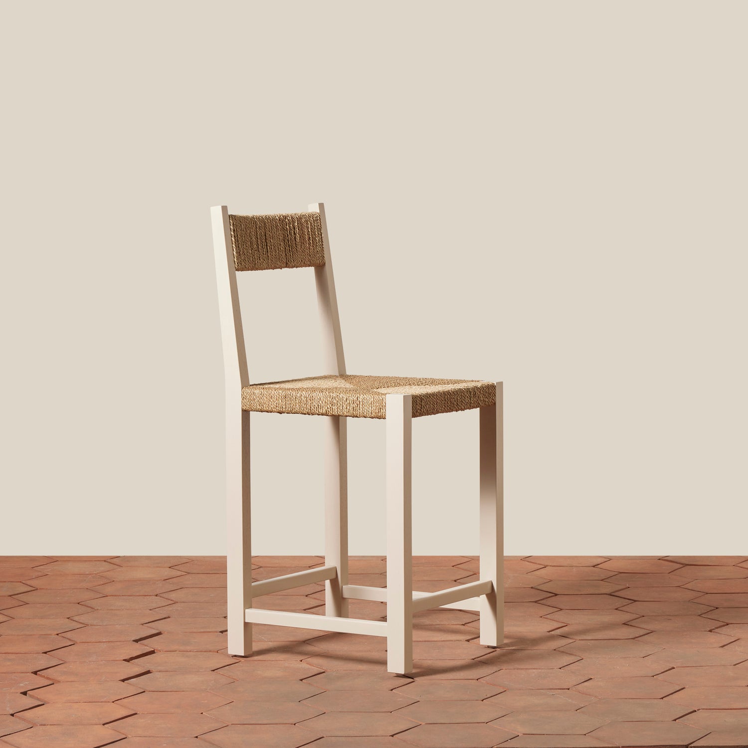 Bar stool with woven seat and backrest on a wooden floor.- Number 13