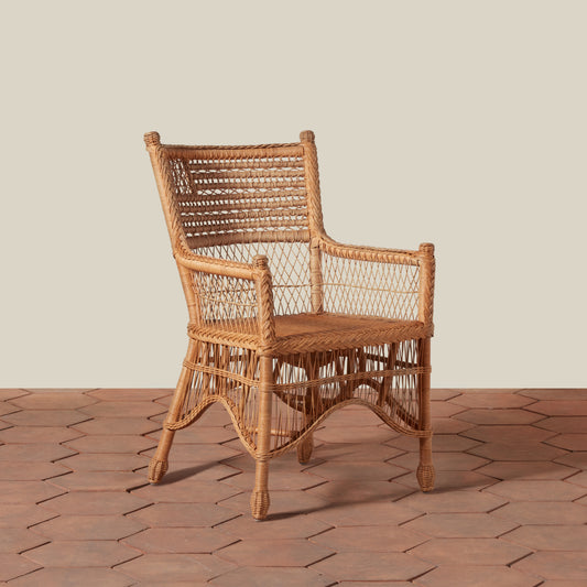 Wicker armchair on a wooden floor with a neutral background