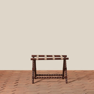 Wooden stool with woven seat on a wooden floor against a beige wall - Number 2