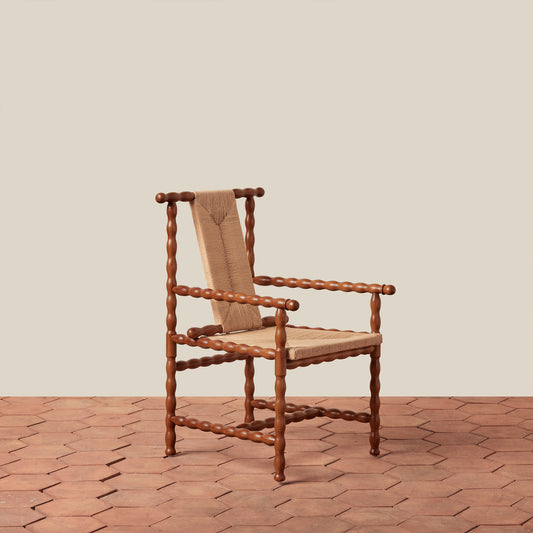 wooden arm chair on tile floor against beige background