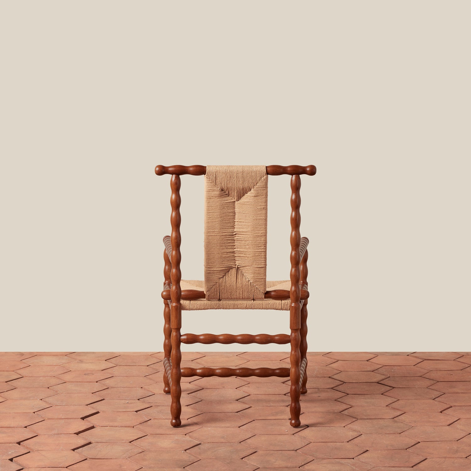 wooden arm chair on tile floor against beige background- Number 4