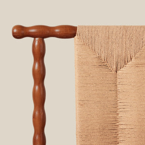 wooden detail on backing on chair against beige background - Number 6