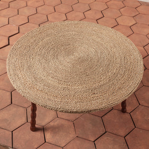 Round woven stool on a hexagonal brick-patterned patio - Number 2