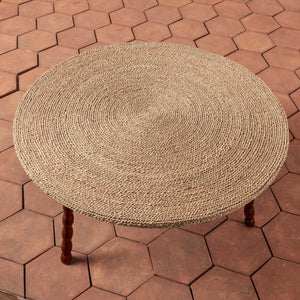 Round woven stool on a hexagonal brick-patterned patio - Number 3