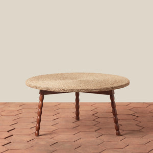 Round woven table with wooden legs on a wooden floor. - Number 1