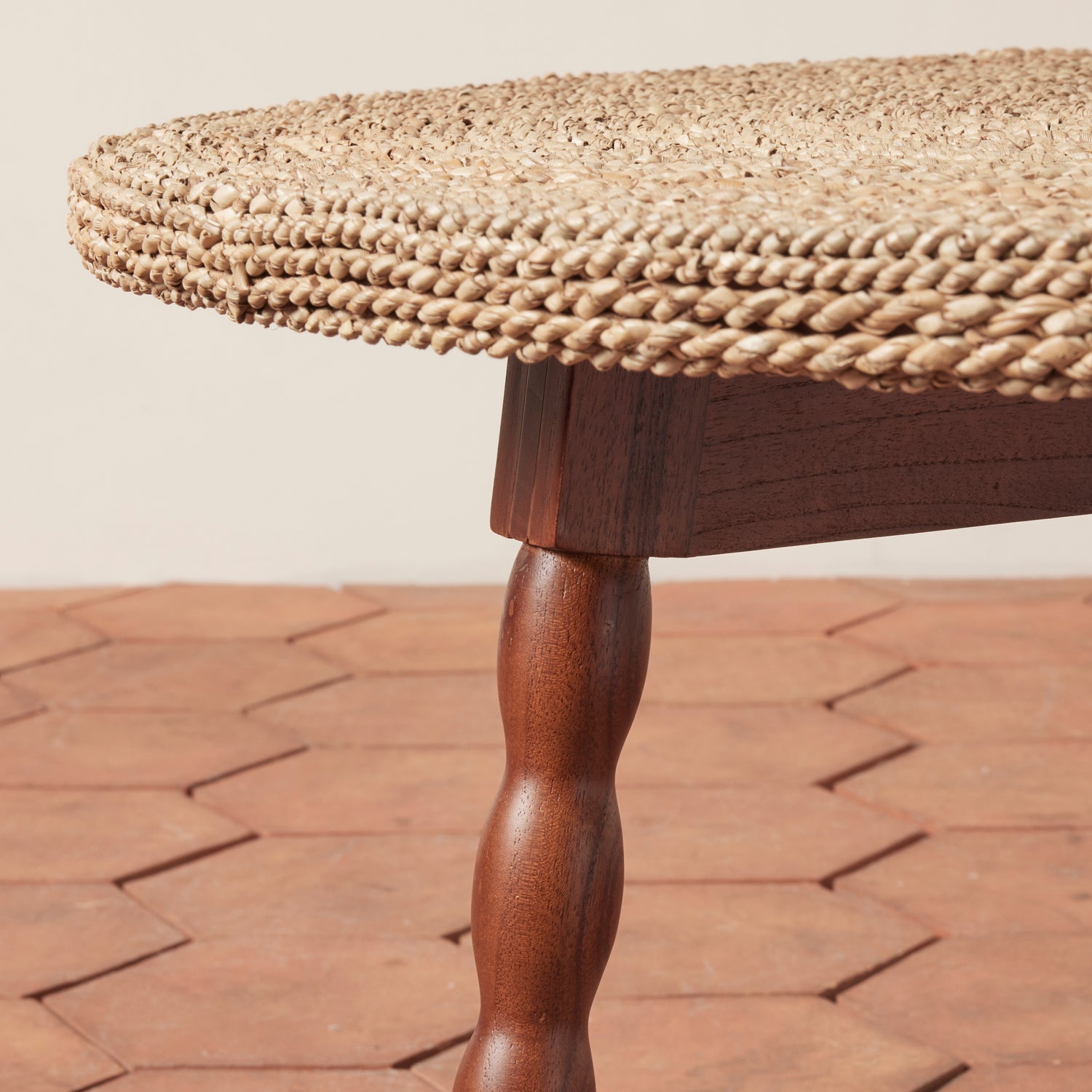 Round wooden table with woven top on a brick patio- Number 3