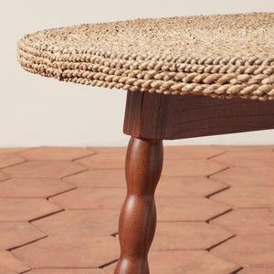 Round wooden table with woven top on a brick patio - Number 3