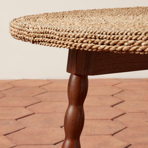 Round woven table with wooden legs on a brick patio - Number 5