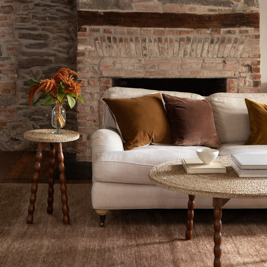 Living room with stone fireplace, white sofa, and decorative items. - Image 2
