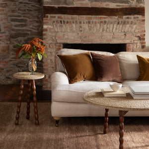 Living room with stone fireplace, white sofa, and decorative items. - Number 2