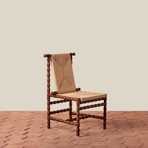 Wooden chair with a woven backrest on a beige floor. - Number 1