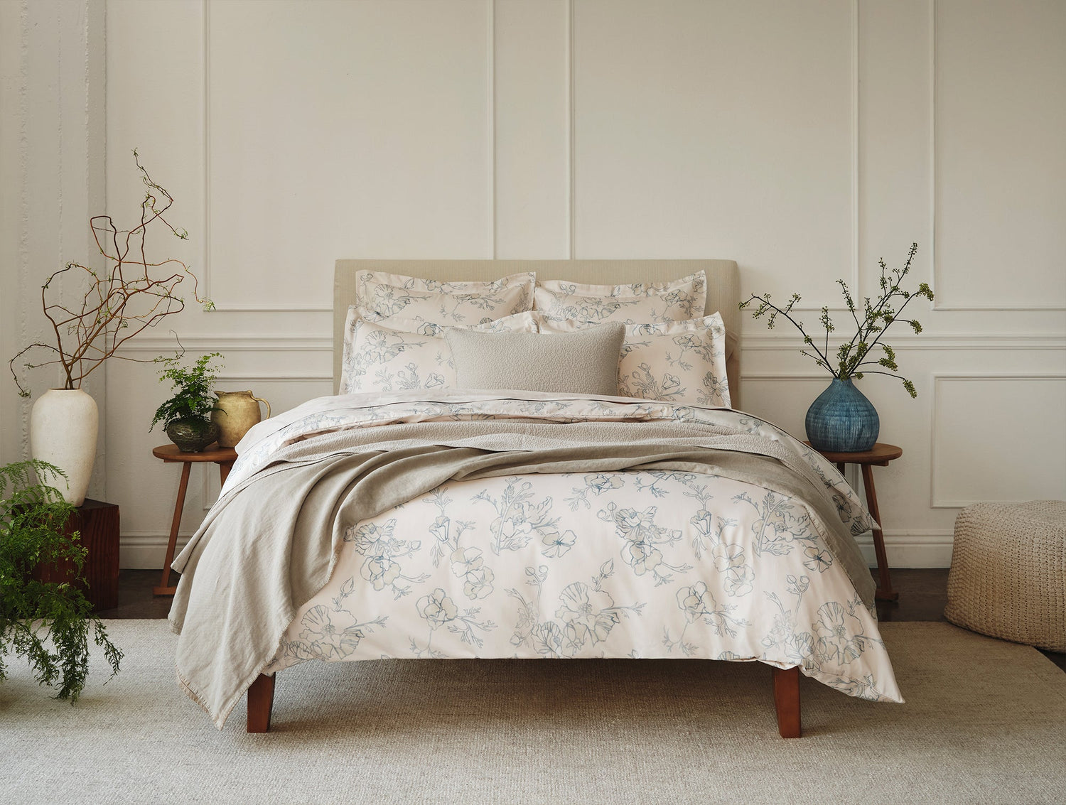 Neatly made bed with floral bedding in a bedroom setting- Number 3
