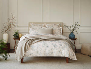 Neatly made bed with floral bedding in a bedroom setting - Number 3