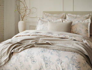 Floral bedding set on a bed with decorative pillows in a bedroom setting. - Number 2