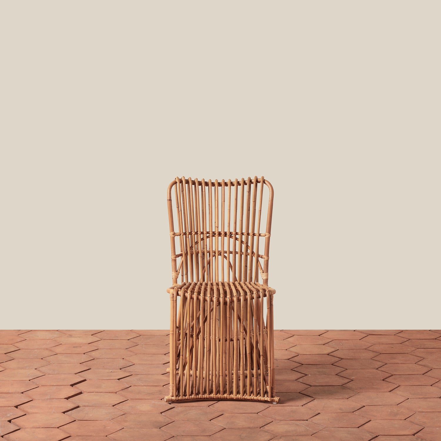 Woven chair on a wooden floor with a beige wall background- Number 3