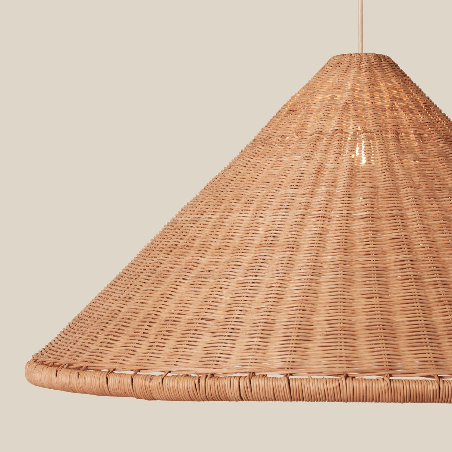 woven brown pendant hanging against neutral background- Number 4