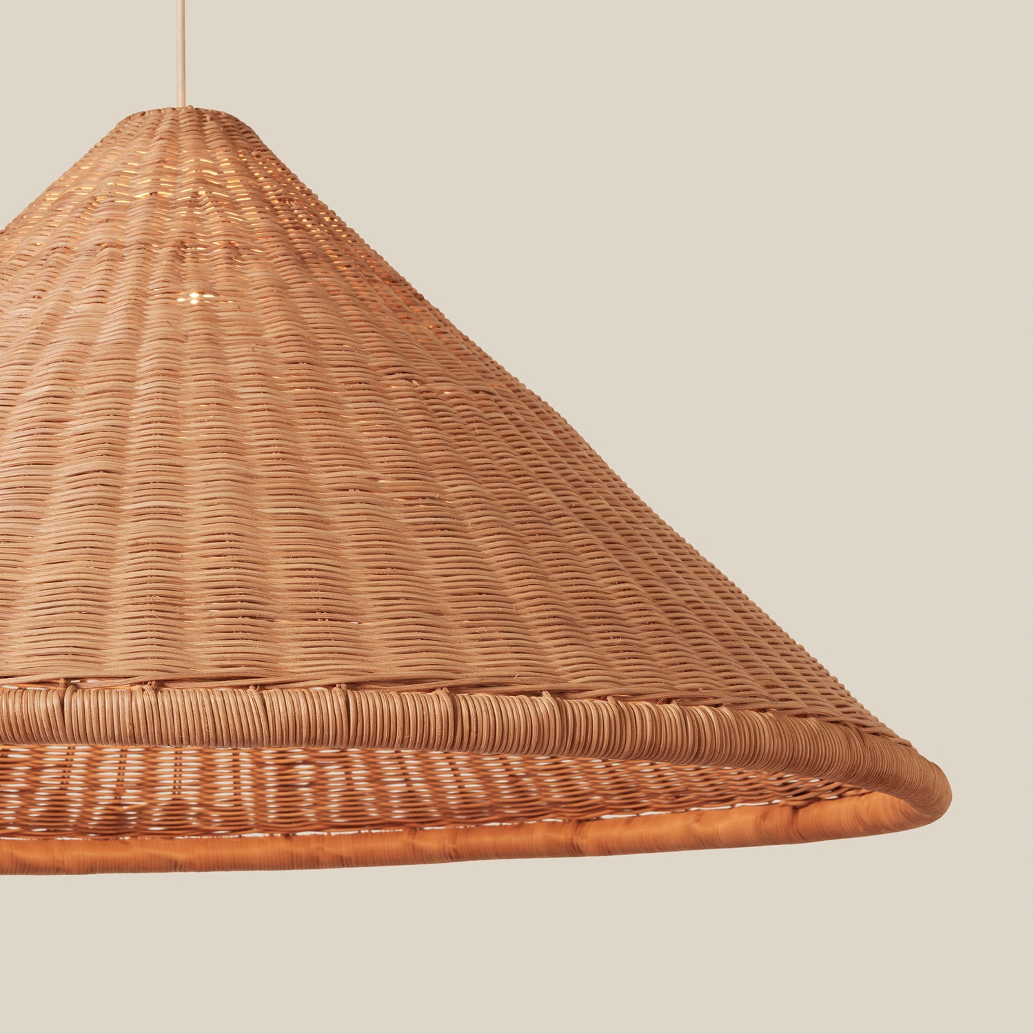 woven brown pendant hanging against neutral background- Number 2