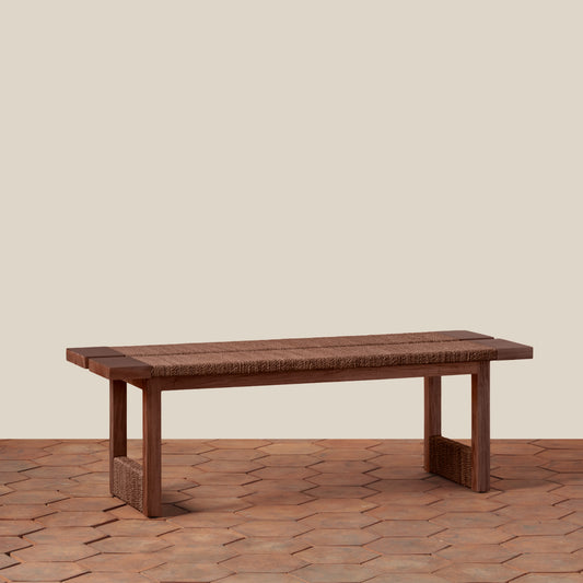 Wooden table on a textured floor with a neutral background