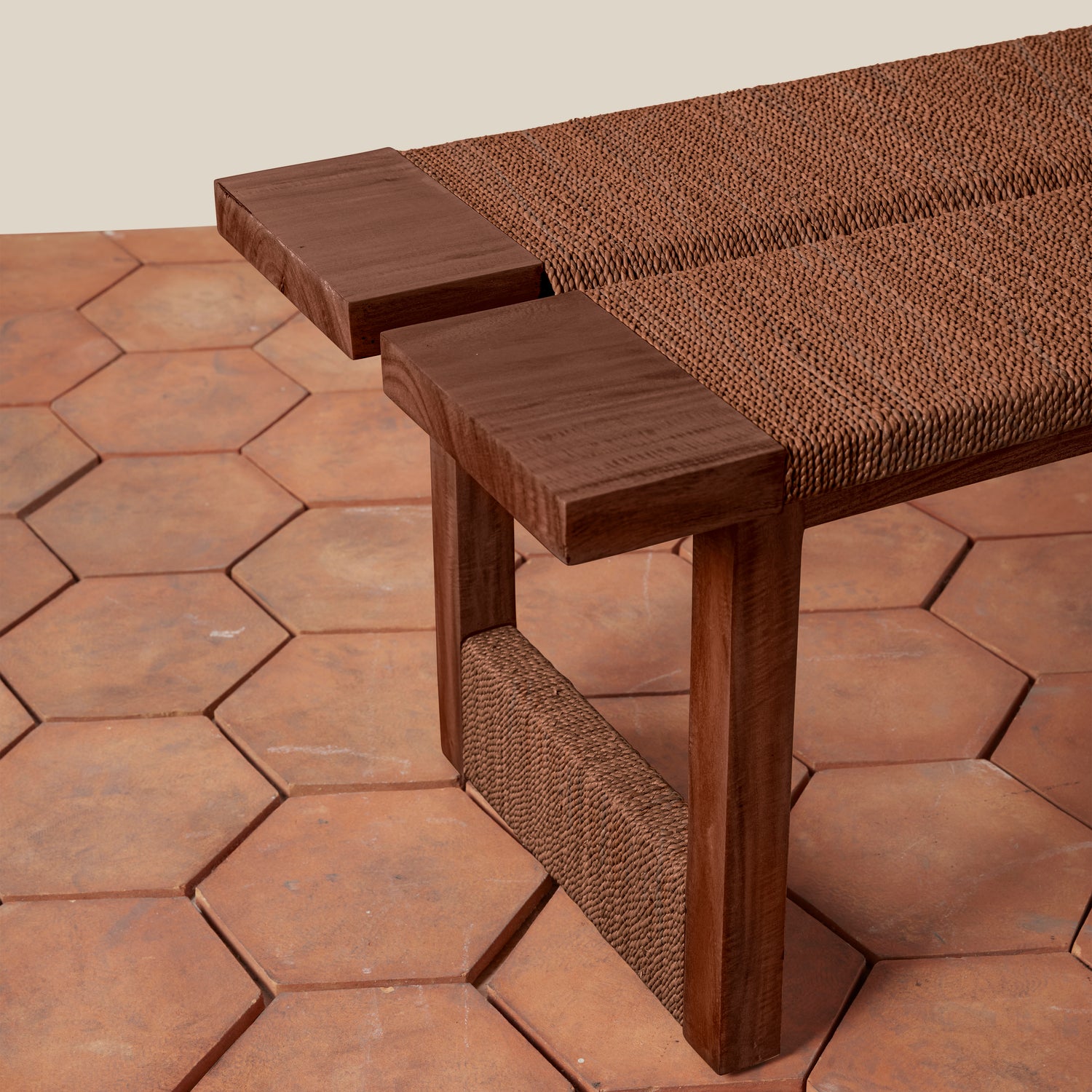 Wooden bench with woven backrest on a hexagonal tile patio- Number 9