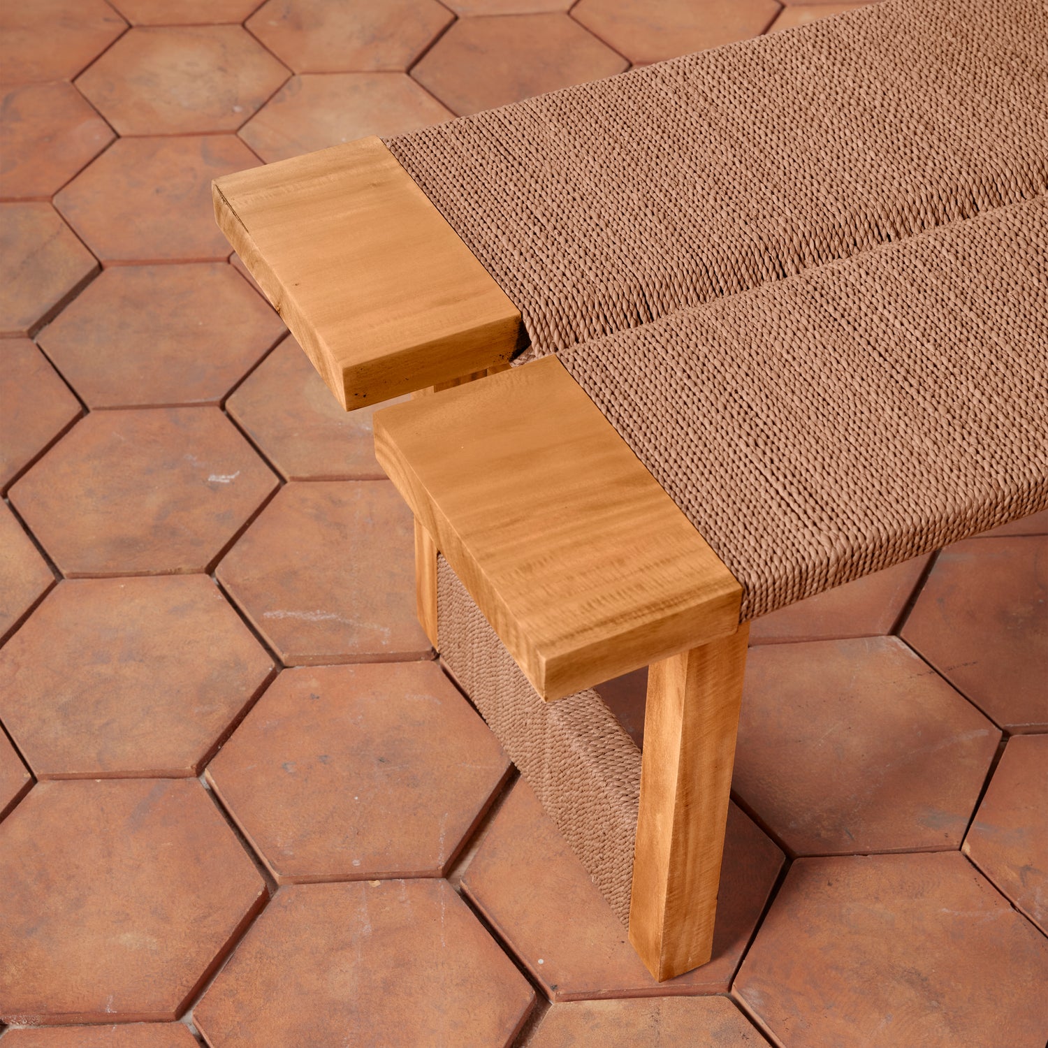 Wooden bench with woven backrest on a hexagonal tile floor- Number 6