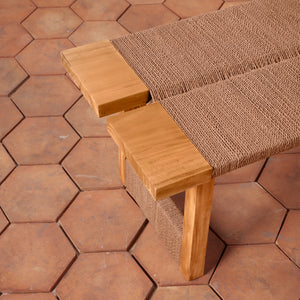 Wooden bench with woven backrest on a hexagonal tile floor - Number 6