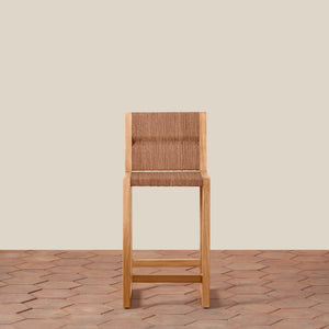 Wooden bar stool with woven backrest on a wooden floor and beige wall background - Number 6