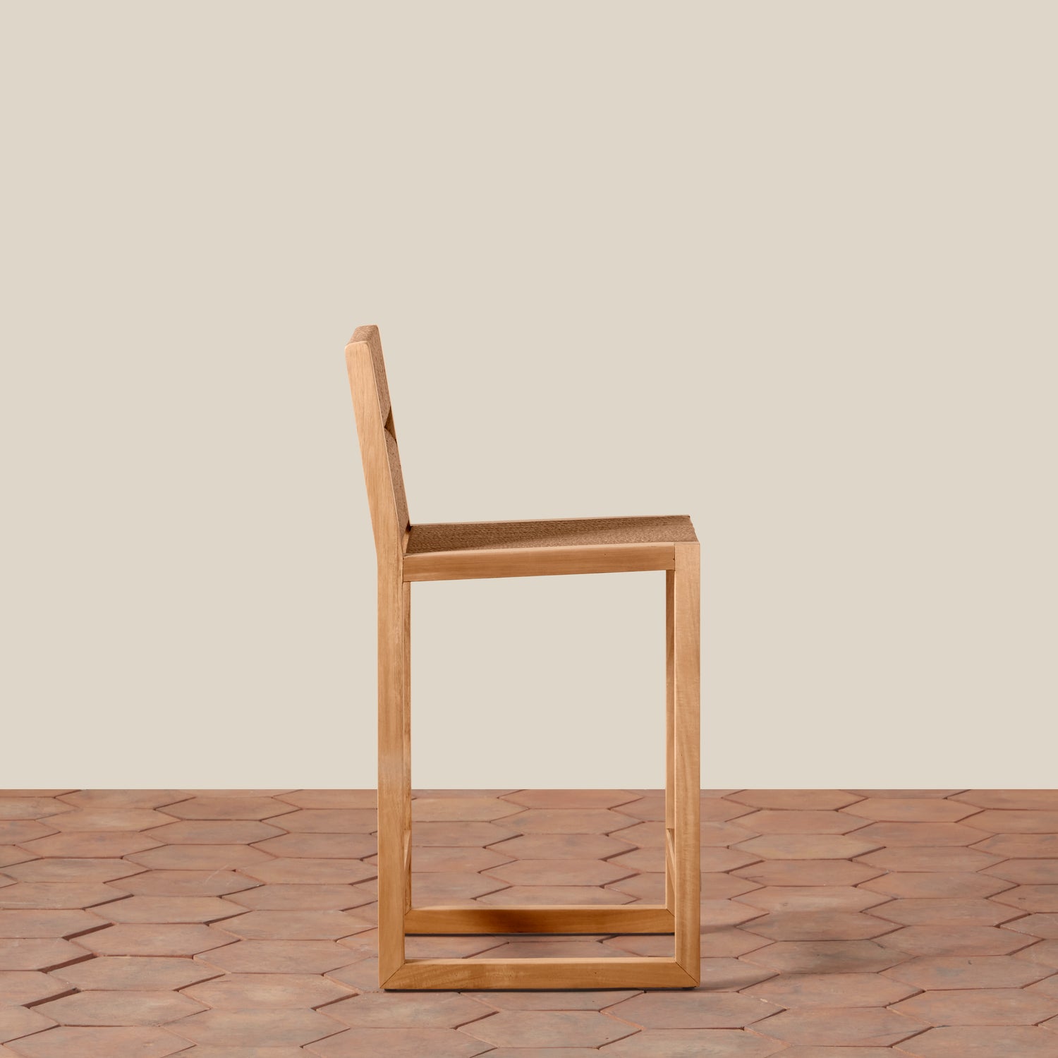 Wooden chair on a wooden floor with a beige wall background- Number 5