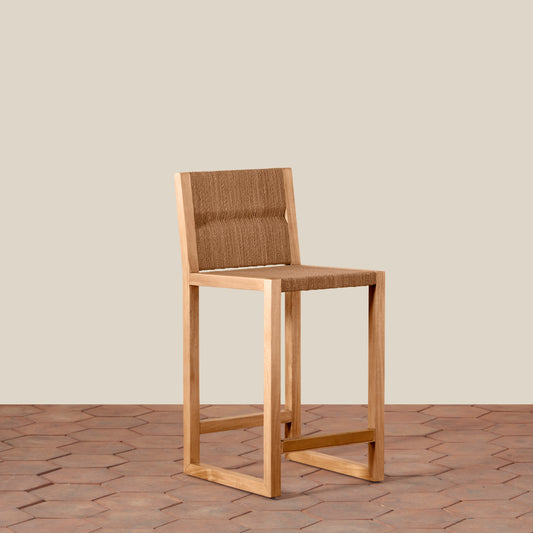 Wooden chair with woven backrest on a wooden floor and beige wall background